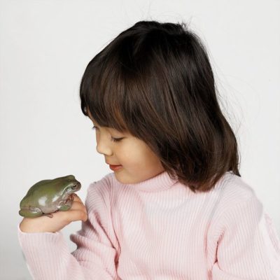 Girl with green tree frog